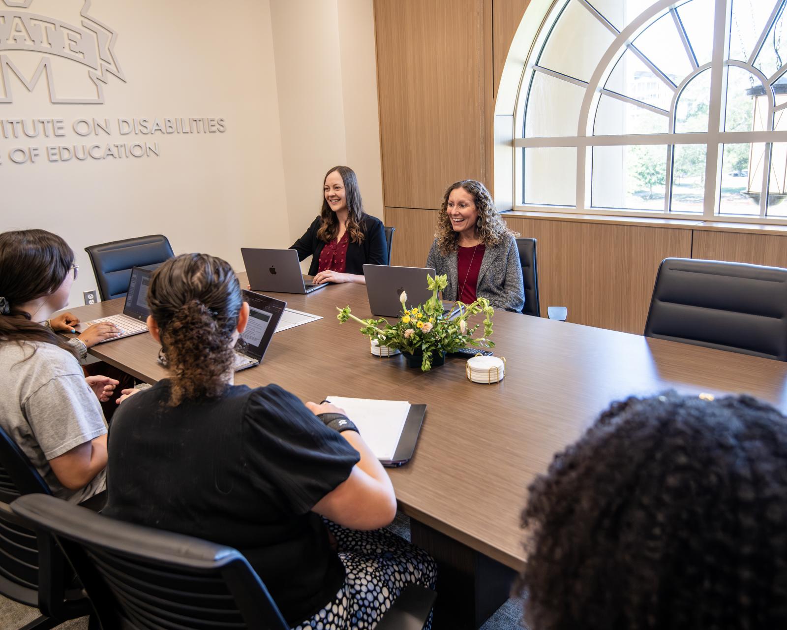 table of graduate students and faculty, staff
