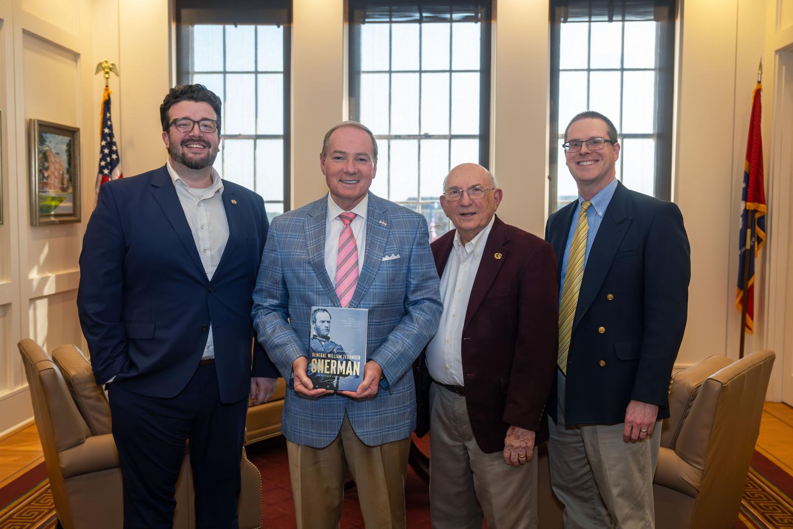 Scholars and editors Louie P. Gallo, left, John Marszalek, third from left, and David Nolen, right, present their new book “The Memoirs of General William Tecumseh Sherman—The Complete Annotated Edition” to Mississippi State University President Mark E. Keenum. The Harvard University Press publication marks 150 years since Sherman’s writing was originally published.