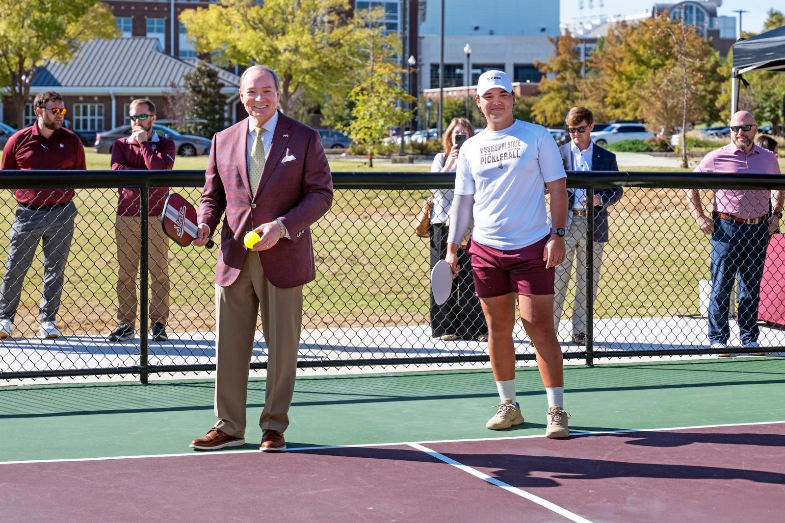 man stands on pickleball court