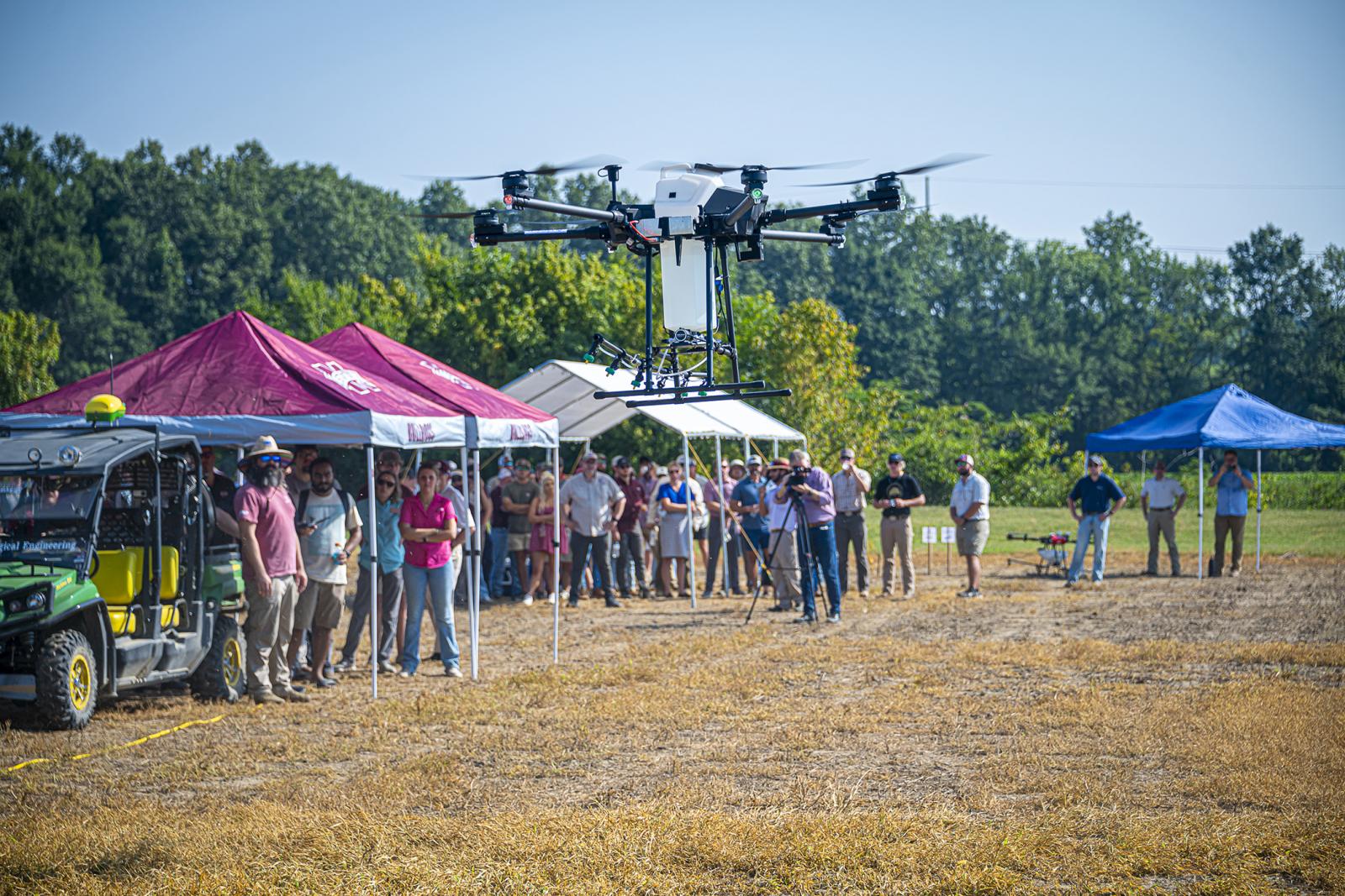 MSU researchers demonstrate unmanned aircraft systems with spray capabilities during a recent agronomy field day.