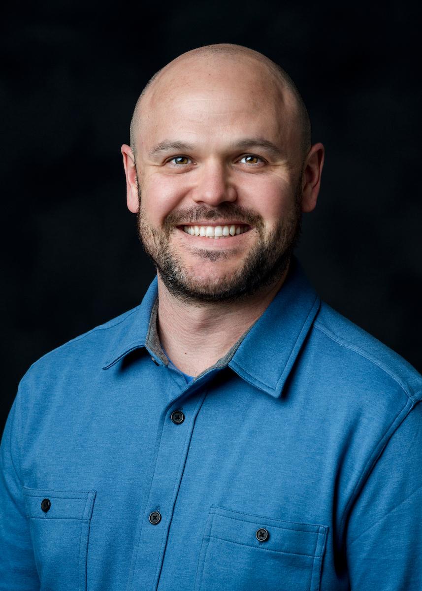 man in blue shirt on black background
