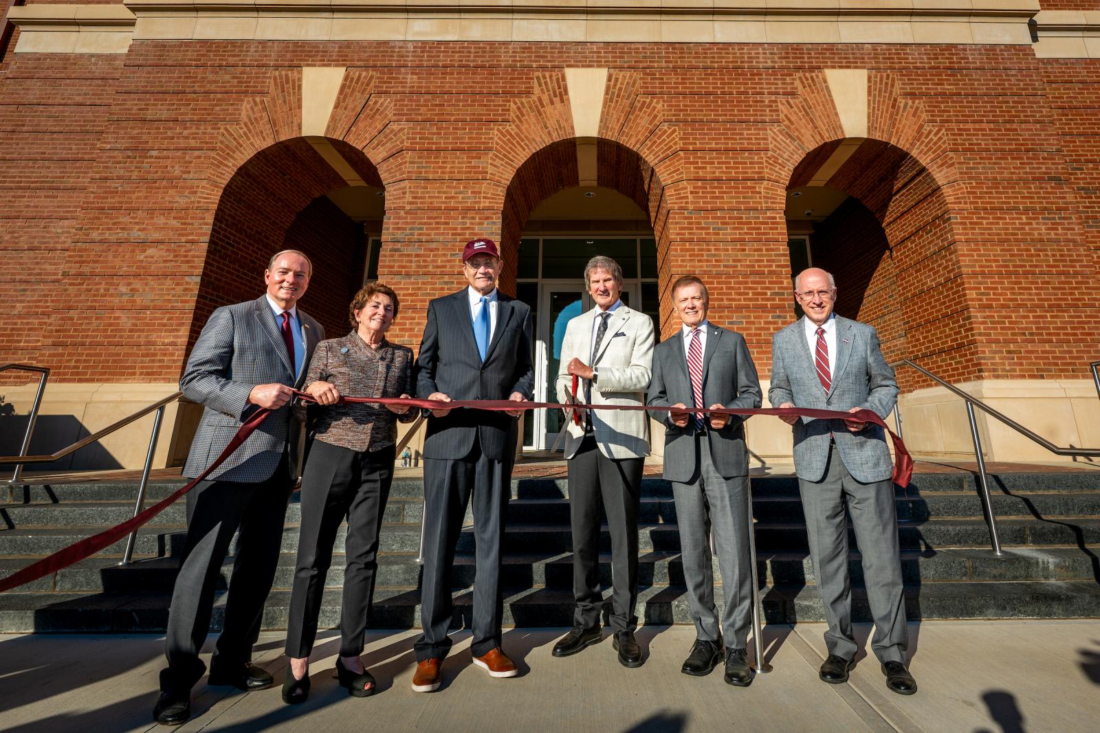 Cutting a ribbon during Wednesday’s [Nov. 5] dedication of the Jim and Thomas Duff Center are, from left, MSU President Mark E. Keenum, Lynn and Lt. Gov. Delbert Hosemann, Jim and Tommy Duff, and MSU Provost and Executive Vice President David Shaw.