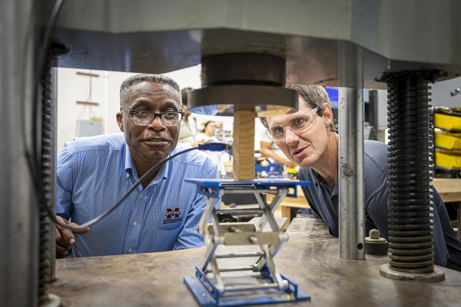 two men working on a machine