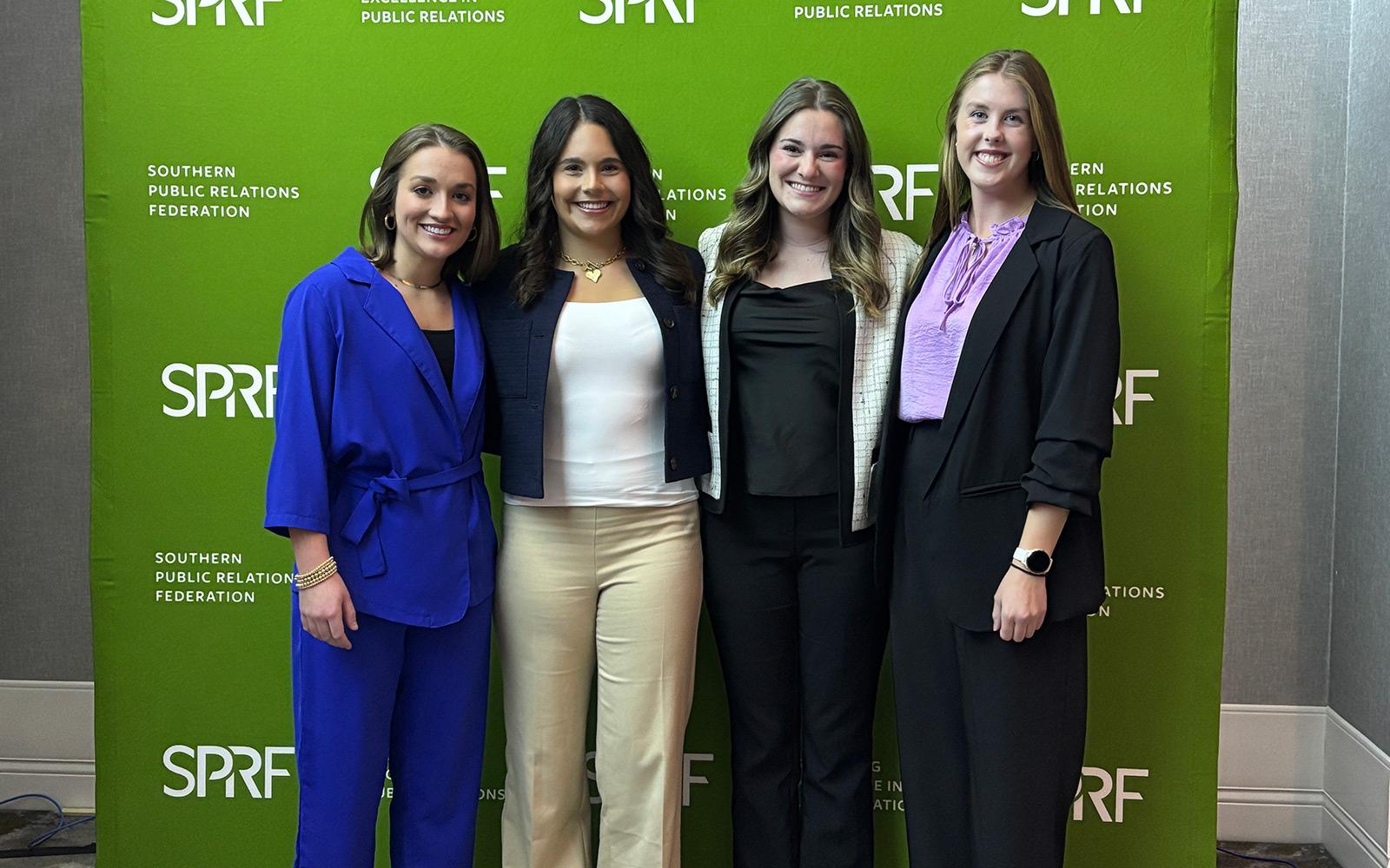 group of young students in front of a green background