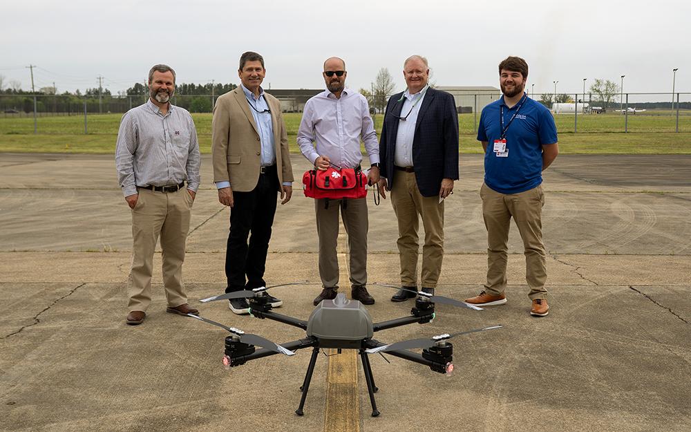 From left, Mississippi State Raspet Flight Research Laboratory Director Bryan Farrell, COLSA Corp. Vice President of Unscrewed Systems James Kennedy, COLSA Corp. Senior Capture Director Daniel Anderson, COLSA Corp. Chief Executive Officer and President Barry Gosnell and COLSA Corp. pilot Jordan Brock stand behind the TALON uncrewed aircraft system recently donated by the company to the university.