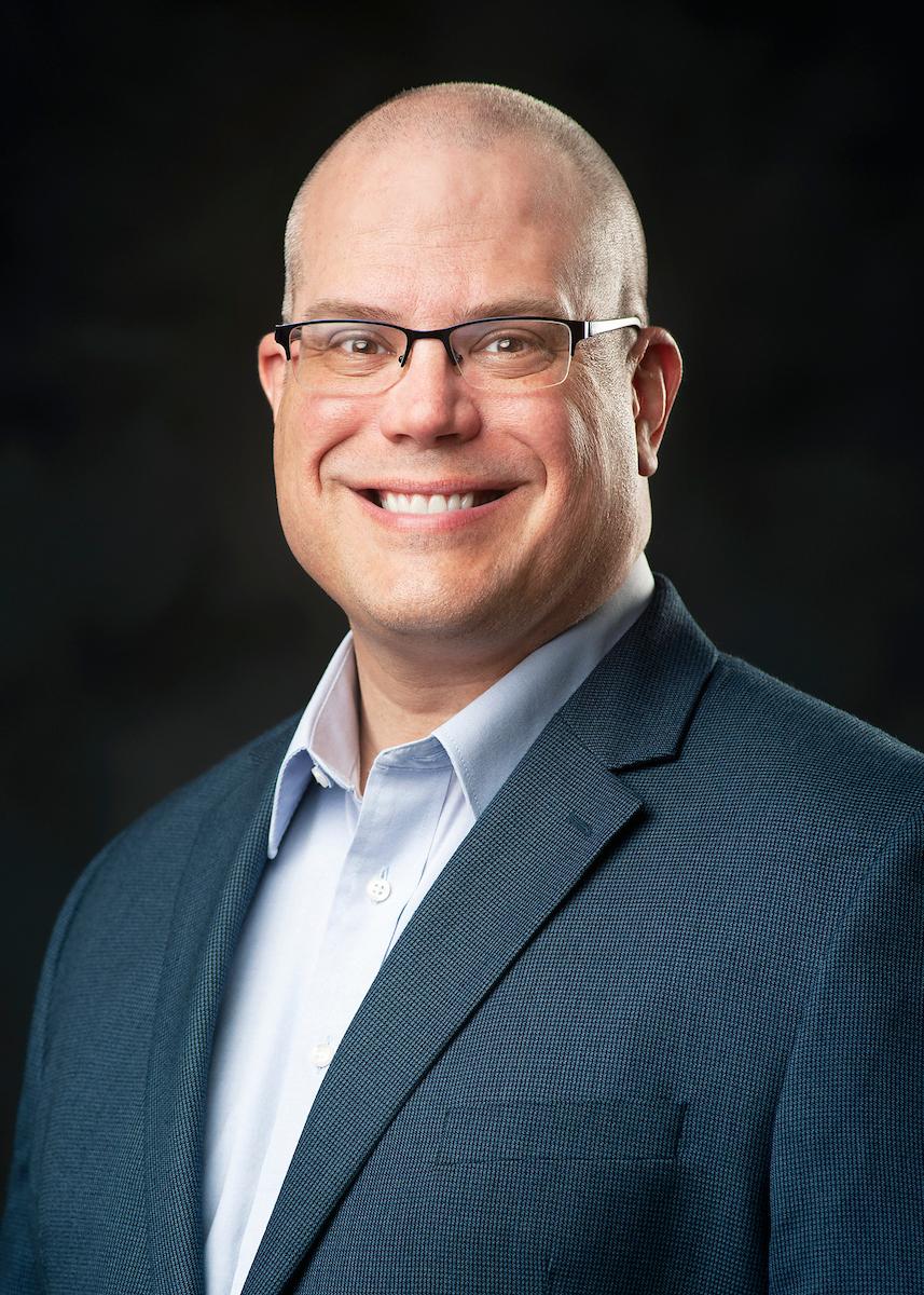 Headshot of Frank Owens on black background