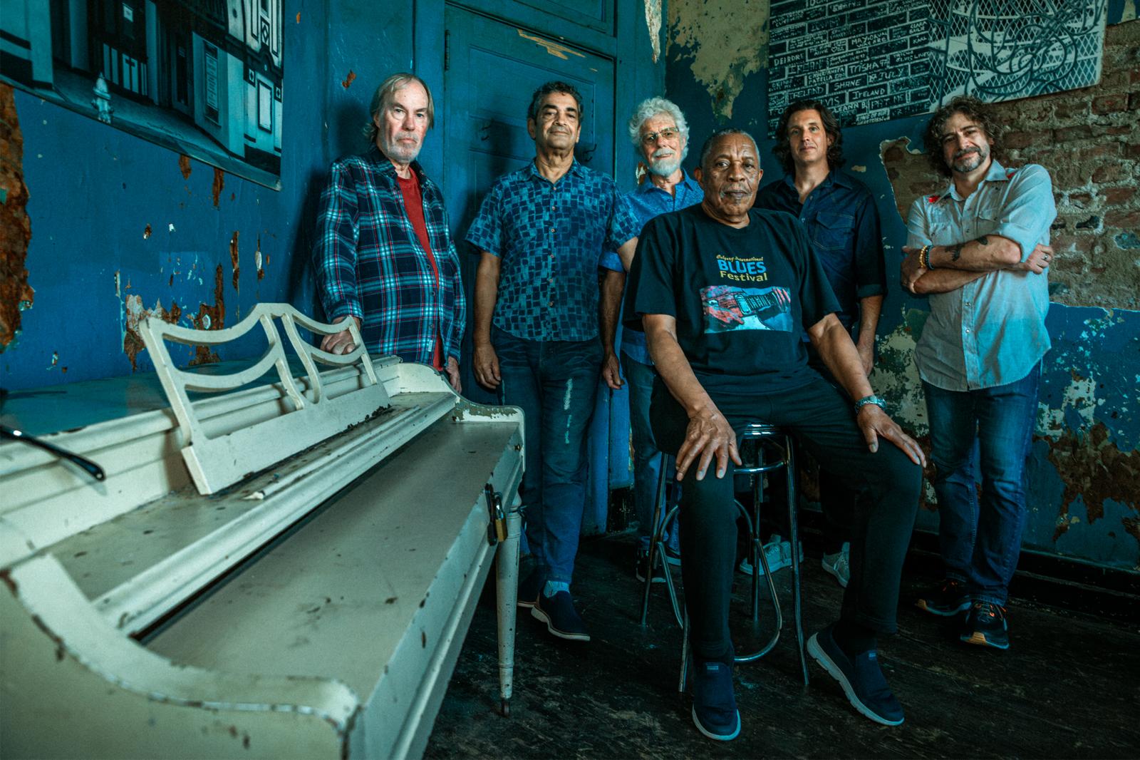 photo of Little feat behind an old piano on a brick wall