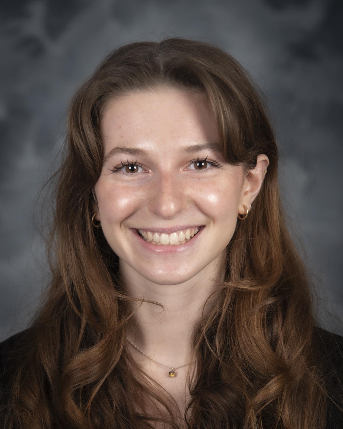 headshot of Lily Behnam on a grey background