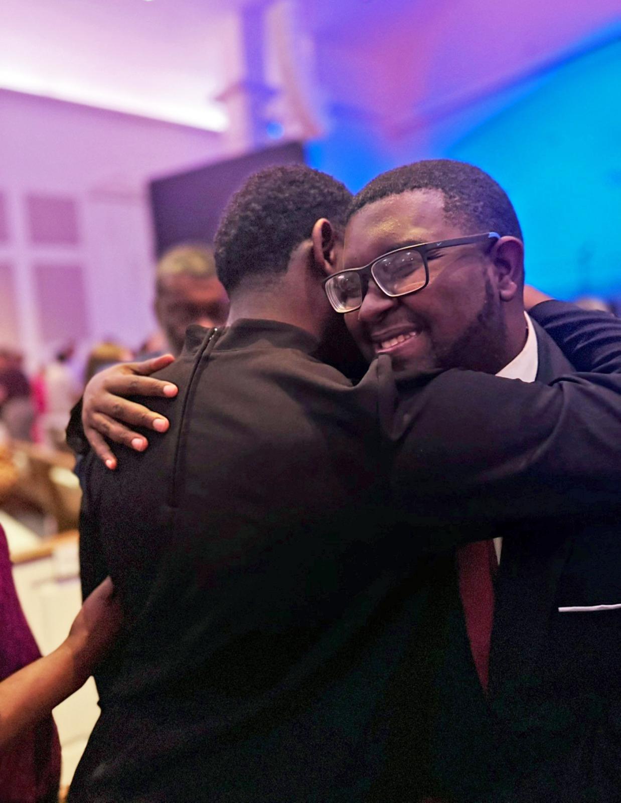 photo of kirk and kirklyn hugging after senior recital.
